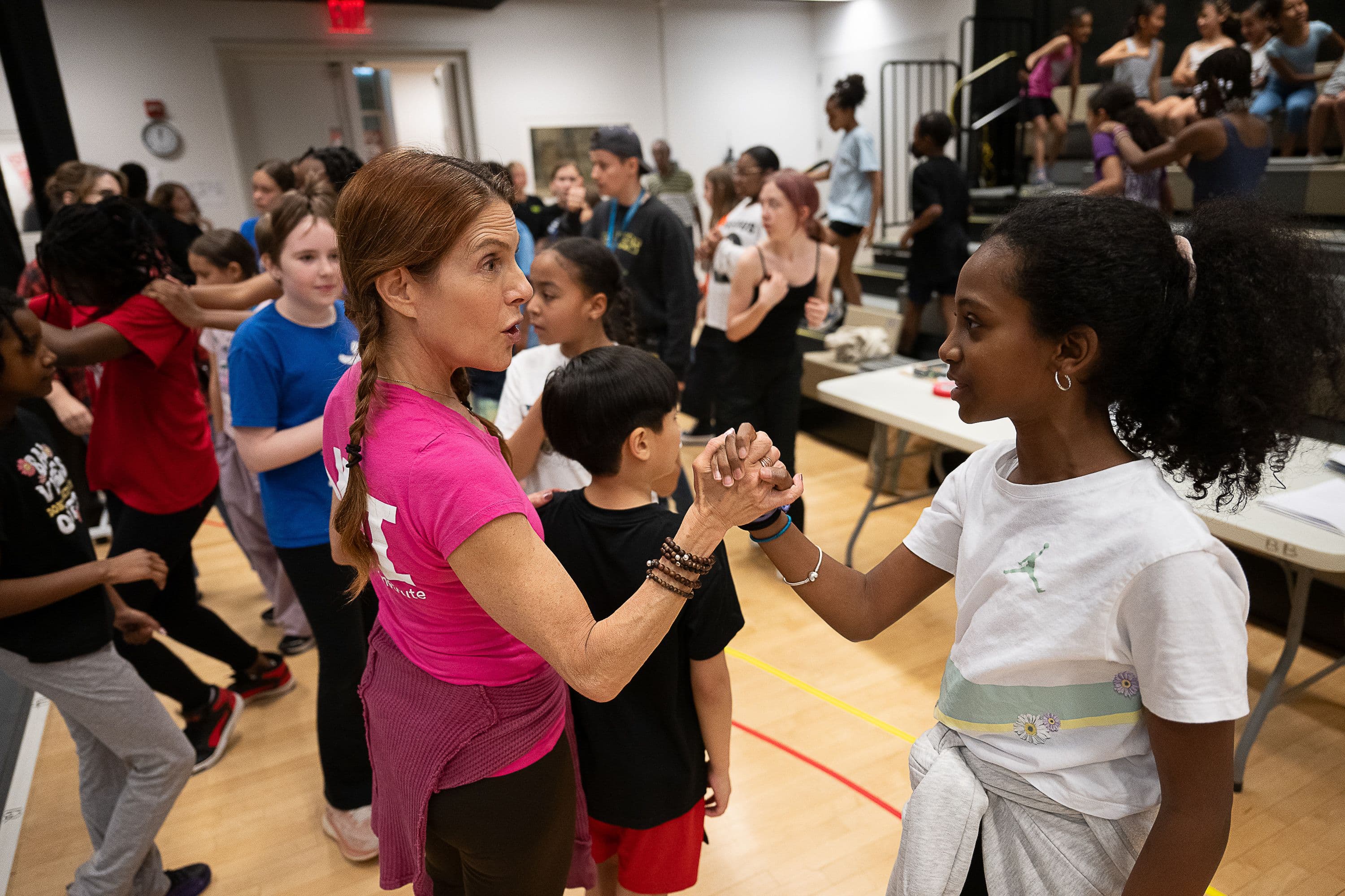 Teacher and student clasping hands