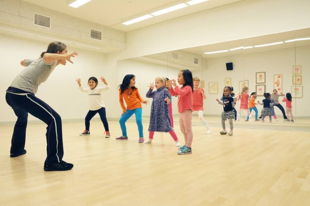 Spacious dance room lined with mirrors