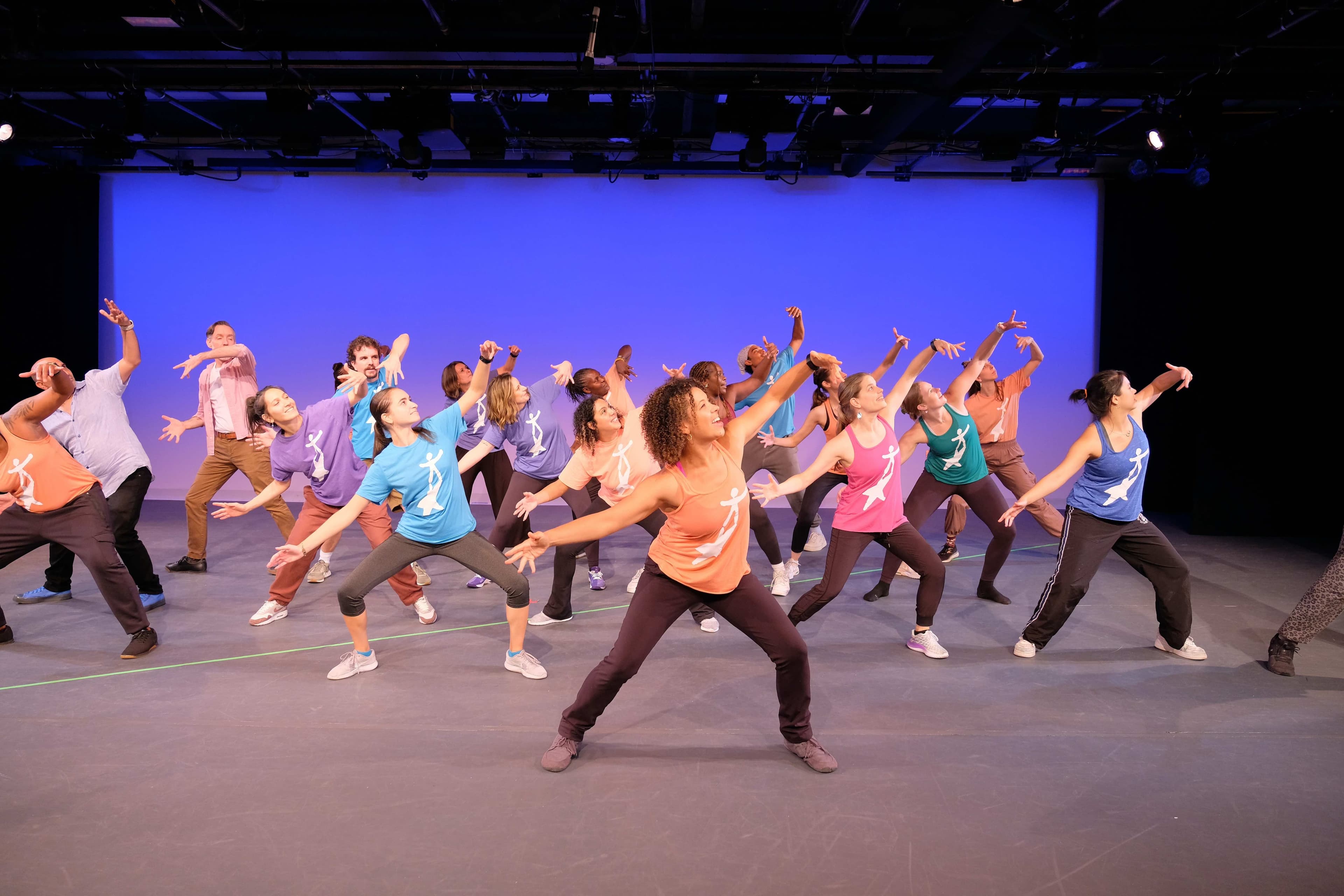Group of people on stage dancing