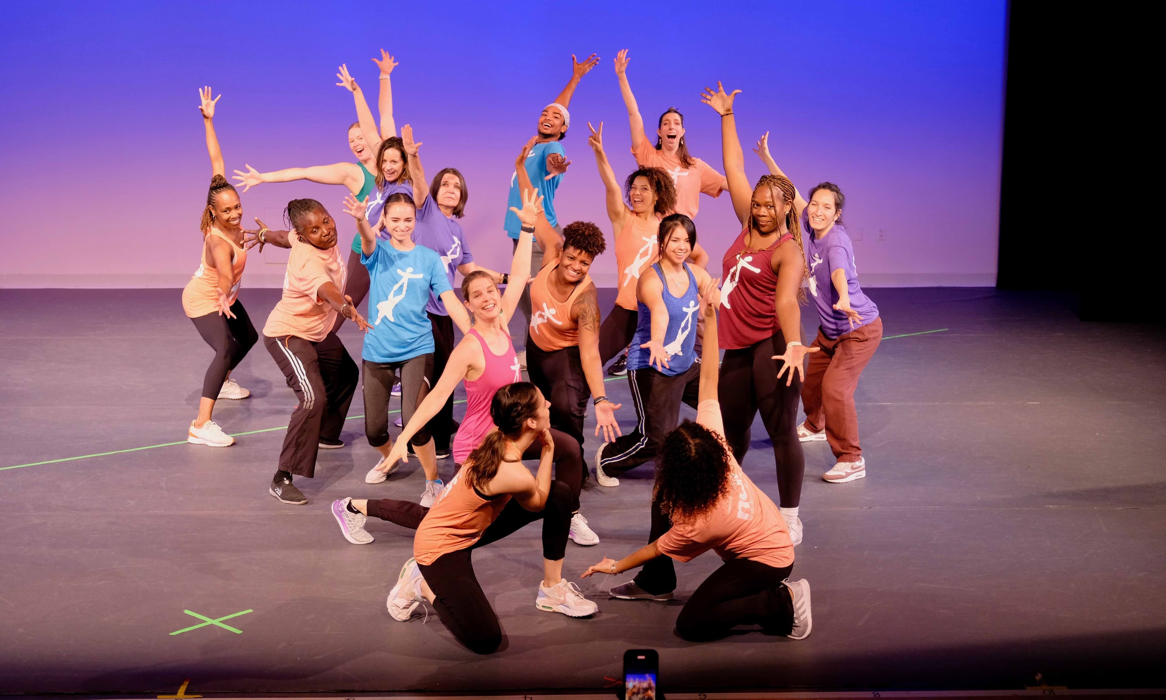 Kids on stage with arms stretched out